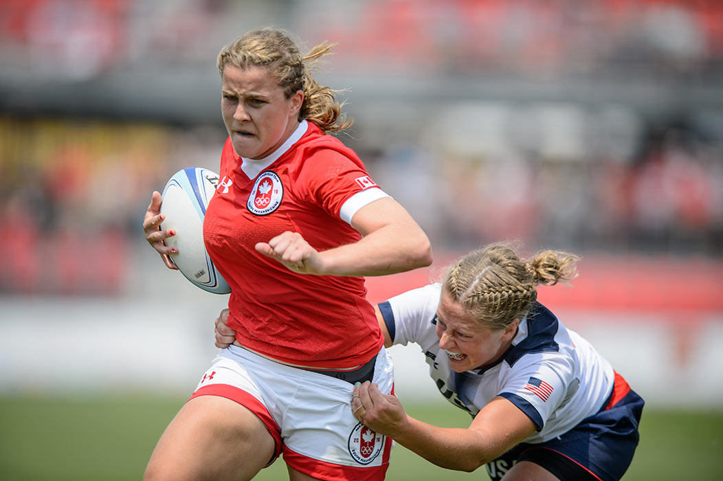 July 13, 2015: Nadejda Popov avoids a tackle from an American player during the rugby sevens final game between Canada and the United States at Exhibition Stadium in Toronto, Ontario, Canada
